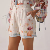 shorts with a beach-themed pattern on a plain background