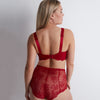 red lace lingerie set on a plain background