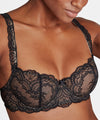 black lace bra on a model against a neutral background