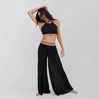 pitusa halter top and wide leg trousers on model in black