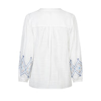 white blouse with blue embroidery on a white background