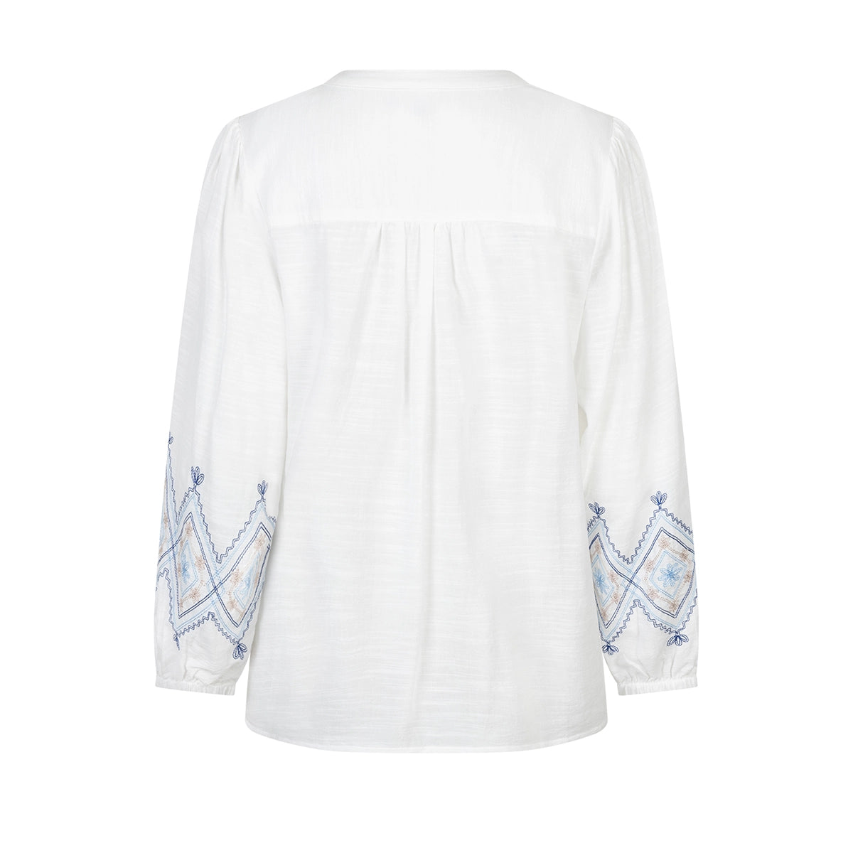 white blouse with blue embroidery on a white background