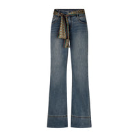 A pair of wide-leg blue denim jeans with a patterned fabric tie belt at the waist, shown against a plain white background.