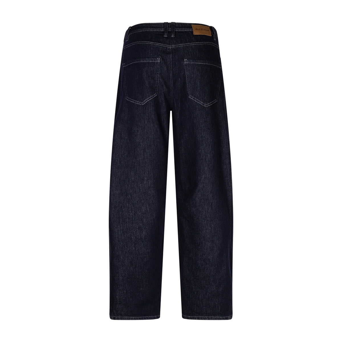 Back view of dark indigo denim jeans on a white background, showing the back pockets and a brown leather brand patch at the waistband.