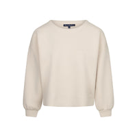 A cream-colored long-sleeve crewneck sweatshirt, featuring a relaxed fit and ribbed cuffs and hem, set against a plain white background.
