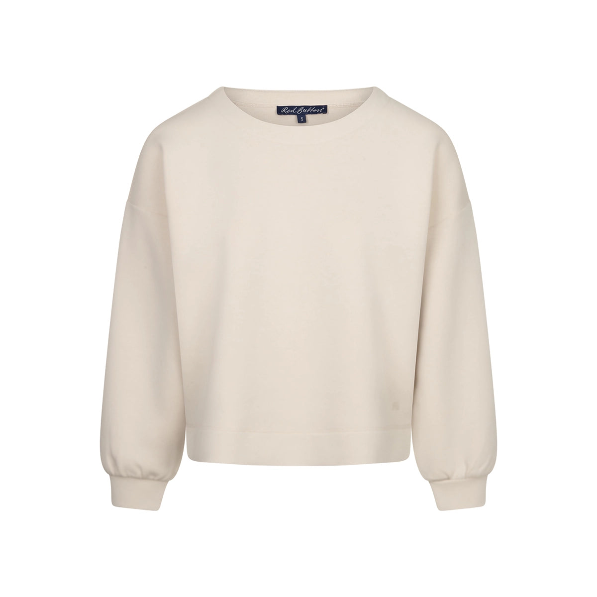 A cream-colored long-sleeve crewneck sweatshirt, featuring a relaxed fit and ribbed cuffs and hem, set against a plain white background.