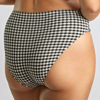 black and white high-waisted bikini bottom on a neutral background