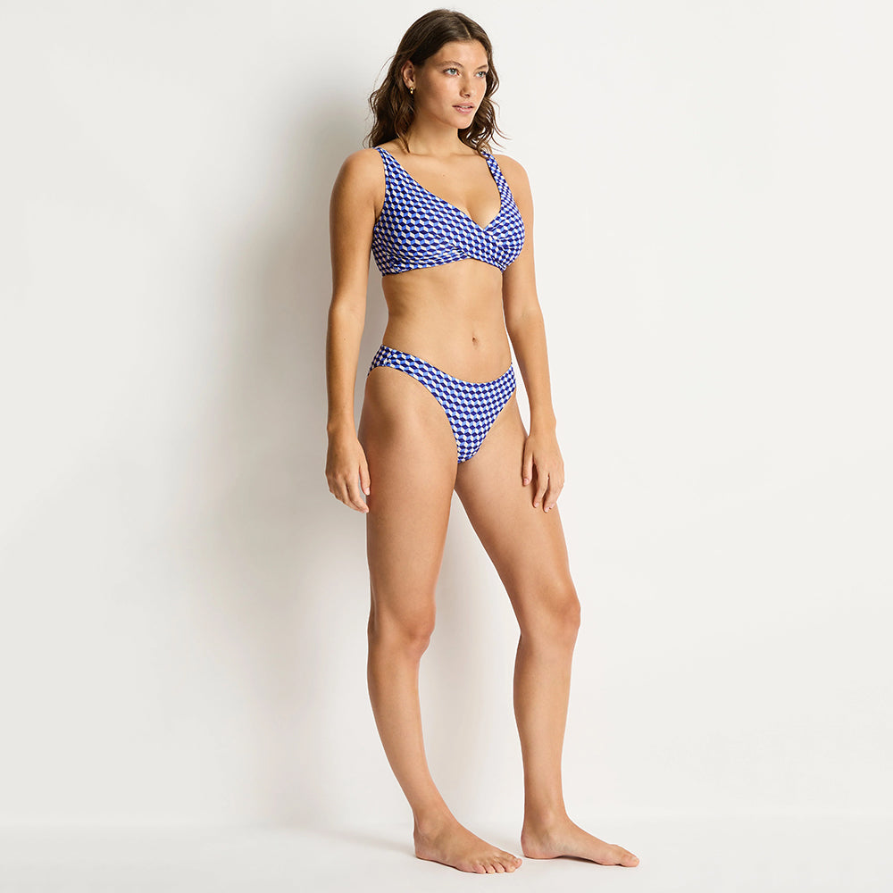 woman wearing a blue and white checkered bikini against a plain background