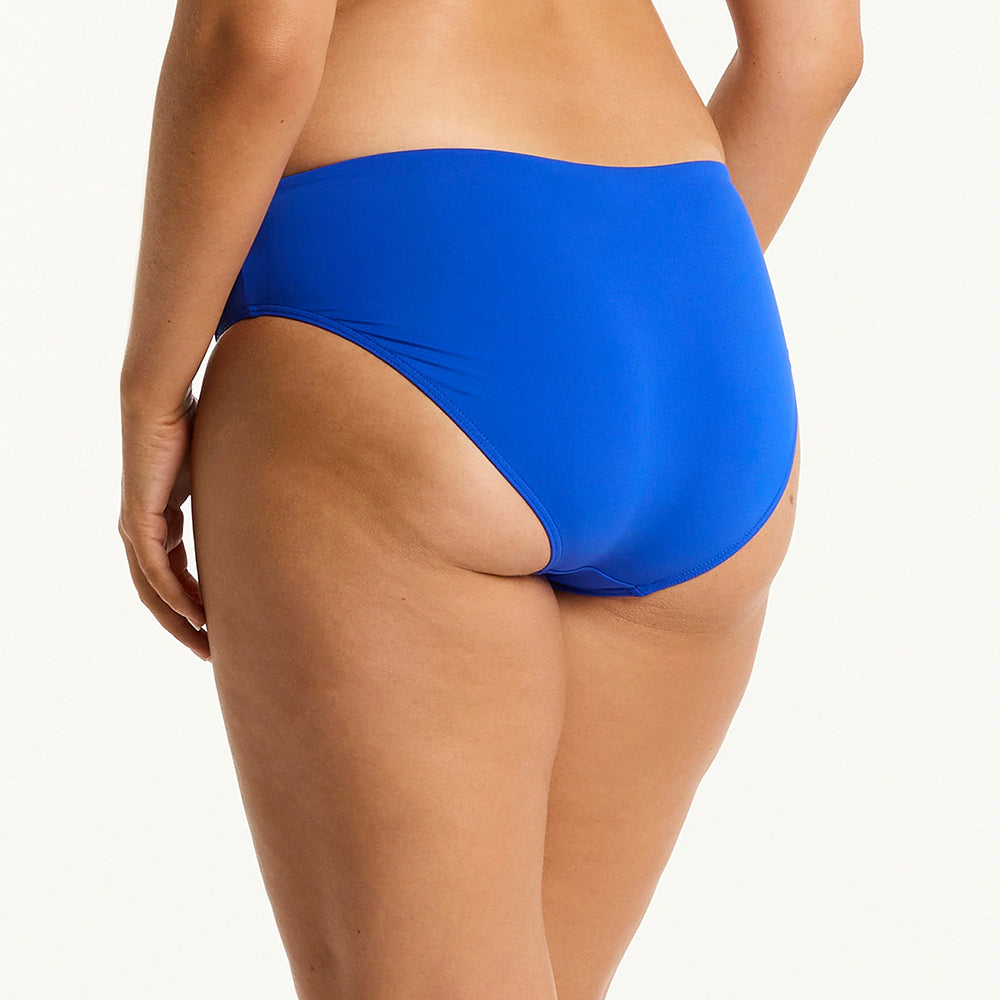 blue bikini bottom worn by a person on a white background
