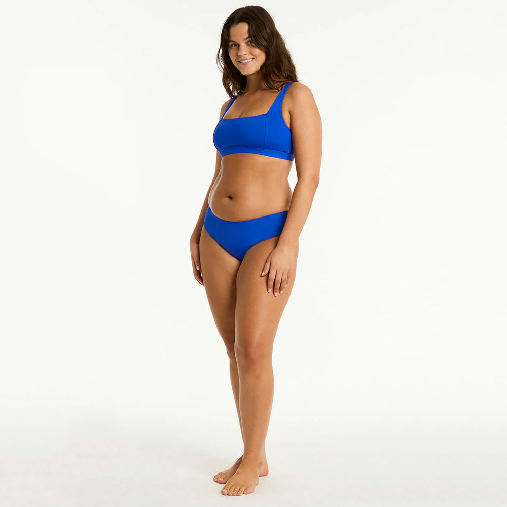 woman wearing a blue bikini on a white background