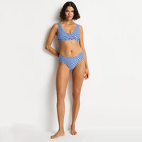woman wearing a blue and white checkered bikini on a white background
