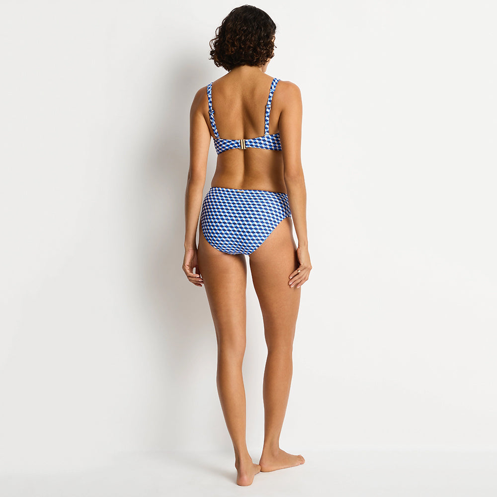 woman wearing a blue and white checkered bikini on a plain background