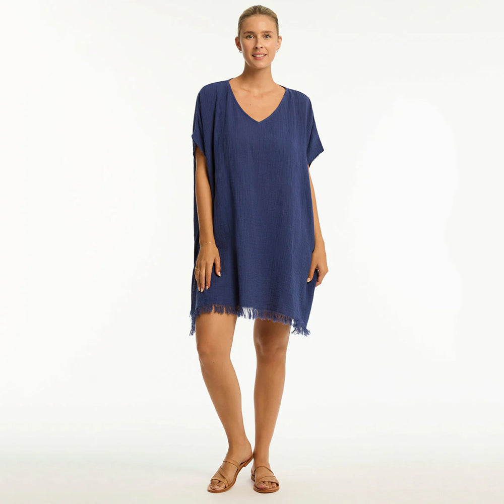 woman wearing a blue beach dress on a white background