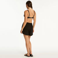 sea level bikini top and black sunset beach shorts on back