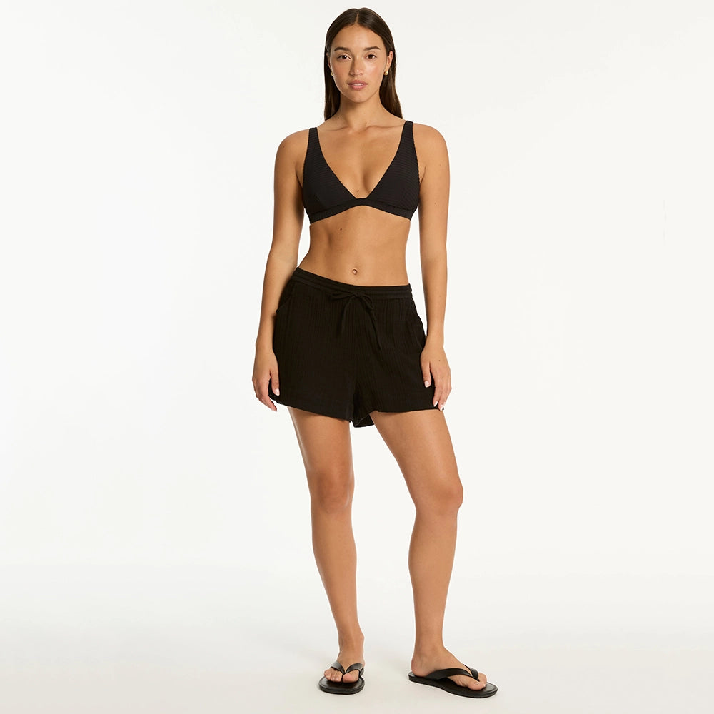 sea level bikini top and black sunset beach shorts on model