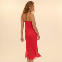 woman wearing a red nightgown against a beige background