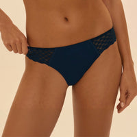 navy blue bikini bottom with mesh details on a beige background
