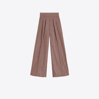 A pair of high-waisted, wide-leg trousers featuring a brown, blue and green plaid pattern with pleated detailing at the front, shown against a plain light gray background.