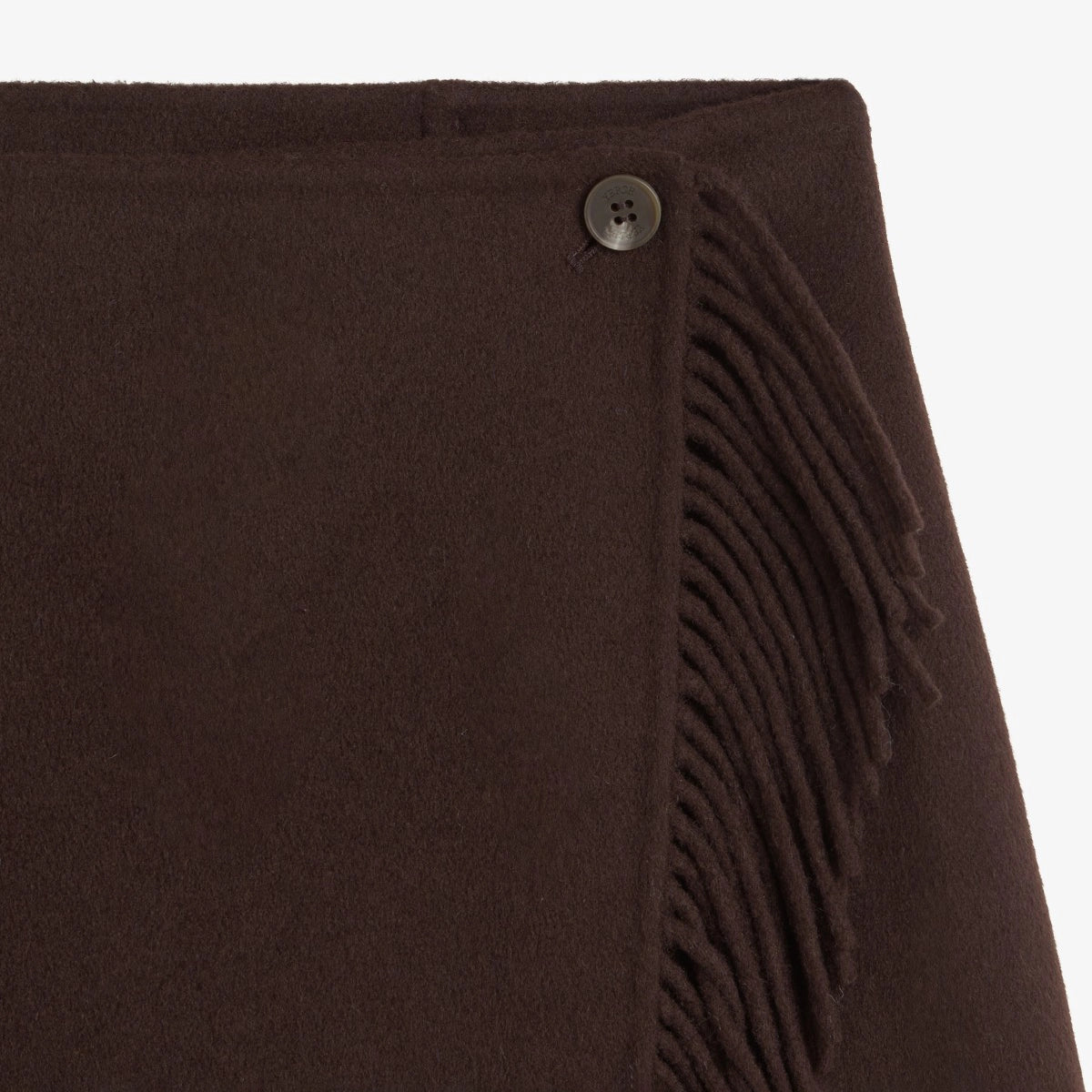 Close-up of a dark brown woolen wrap or scarf with fringe trim and a small dark button detail, shown against a plain white background.