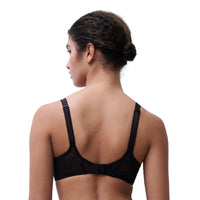 A woman shown from the back wearing a black lace underwire bra against a plain white background.