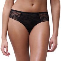 Black lace panties modeled on a person against a plain white background.