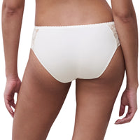 Rear view of a model wearing white lace-trimmed underwear against a plain white background.