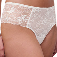 White lace panties with floral lace patterns and bow details, shown on a model.