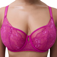 A close-up of a model wearing a bright pink lace bra with butterfly patterns and matching underwire cups.