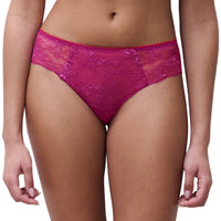A model wearing bright magenta lace panties against a plain white background.