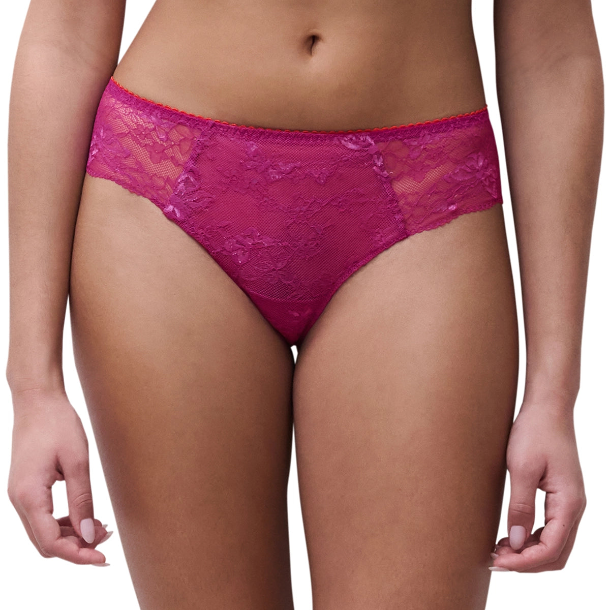 A model wearing bright magenta lace panties against a plain white background.