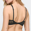 black lace bra worn by a person on a plain background