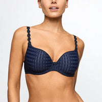 Navy blue bra with floral detailing on straps worn by a model against a white background