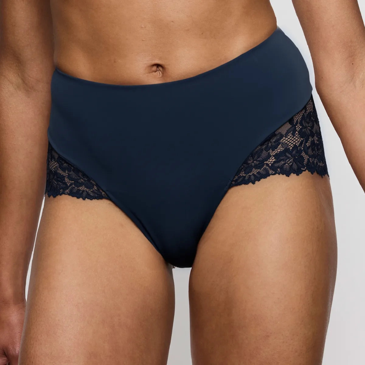Navy blue high-waisted underwear with lace detailing on a neutral background
