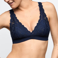 Navy blue lace bra on a plain background