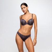 a woman modeling a two-piece bikini set with a dark gray and black plaid pattern accented by thin red and pink lines, set against a plain light gray studio background.