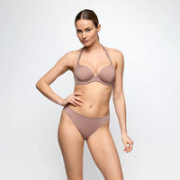 marie jo tom lingerie set in neutral colour worn by a model on a plain background