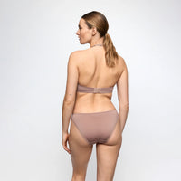 A woman shown from the back wearing a matching two-piece underwear set in a muted taupe-brown color, photographed against a clean light gray studio background.