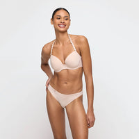 woman wearing a beige bikini on a white background