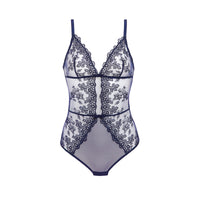 A sheer white and navy blue lace bodysuit with thin straps, floral lace panels, and a center front lace overlay, shown against a plain white background.